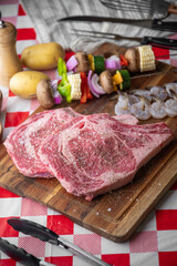 fresh ribeye steak with skewered shrimp and vegetable