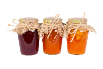 Glass jars with red and yellow jam, the lid on top is tied with a rough cloth and hemp rope. Isolate on white background.
