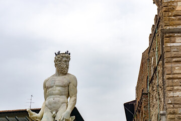 Fototapeta na wymiar Neptune fountain on Signoria square, Florence, Italy