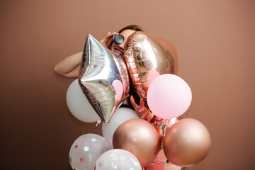 girl with red balloons laughs, isolated on background.