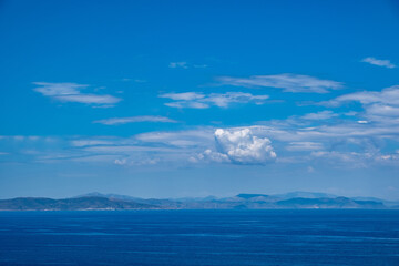 Blue sea and sky background, blue shades and white clouds