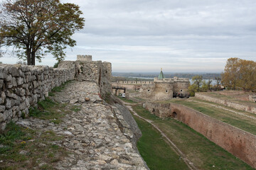 Fototapeta na wymiar View from the inner wall of the Kalemegdan fortress to the wide moat, to the Zindan gate, to the dome of the Church of the Ruzhitsa and the Danube River