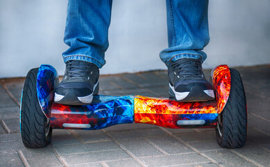 Man on a hoverboard. Balancing on an electric scooter in the open air.