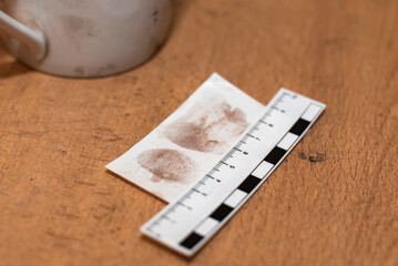paper ruler and fingerprints on a sheet in the investigator's office. Fingerprint police uniforms....