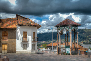 Cuenca, Ecuador, November 2013: Beautiful gazebo and colonial house,  which are part of the Ford Square (Plazoleta del Vado), on a cloudy afternoon.