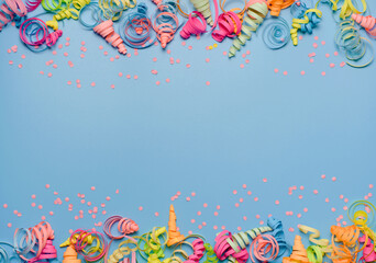 Naklejka na ściany i meble party background with colorful streamers for celebrating birthday. space with scattered confetti. Colorful celebration concept. Copy space on blue background
