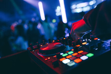 producer  DJ mixer in a nightclub with glowing plays musical rave Dubstep Electronic Trance...