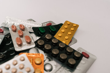 Tablets in packaging on white background.