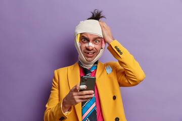 Frustrated puzzled man takes revenge from someone, keeps hand on head, gets strange message on...