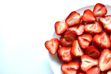 Berries of ripe and delicious strawberries on a white plate