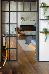 luxury studio apartment with a free layout in a loft style in dark colors. Stylish modern kitchen...
