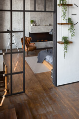 luxury studio apartment with a free layout in a loft style in dark colors. Stylish modern kitchen...