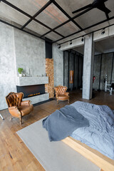luxury studio apartment with a free layout in a loft style in dark colors. Stylish modern kitchen...