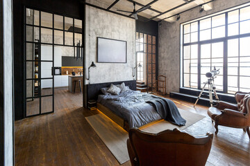 luxury studio apartment with a free layout in a loft style in dark colors. Stylish modern kitchen...