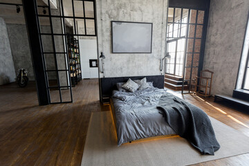 luxury studio apartment with a free layout in a loft style in dark colors. Stylish modern kitchen...