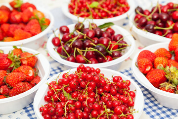 Summer fruits. Freshly harvested cherries, strawberries and red currant fruits