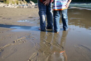 children walking on the dirty sandy beach