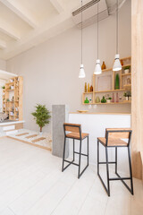 Luxury fashionable modern design studio apartment with a free layout in a minimal style. very bright huge spacious room with white walls and wooden elements. sitting area with fireplace