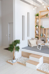 Luxury fashionable modern design studio apartment with a free layout in a minimal style. very bright huge spacious room with white walls and wooden elements. sitting area with fireplace