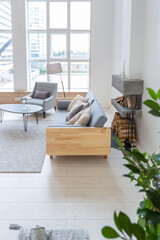 Luxury fashionable modern design studio apartment with a free layout in a minimal style. very bright huge spacious room with white walls and wooden elements. sitting area with fireplace
