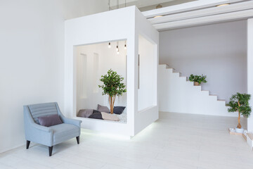 Luxury fashionable modern design studio apartment with a free layout in a minimal style. very bright huge spacious room with white walls and wooden elements. sitting area with fireplace