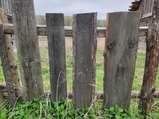 Fototapeta premium Fence from the boards. The texture of the old boards. Wooden elements of the fence.