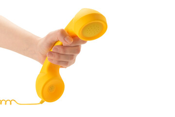 Yellow handset in woman hand isolated on white.