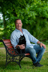Fototapeta premium man sitting on a bench with a dog