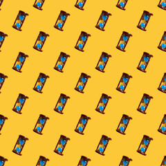 hourglass with blue sand seamless pattern over yellow background. minimal concept.
