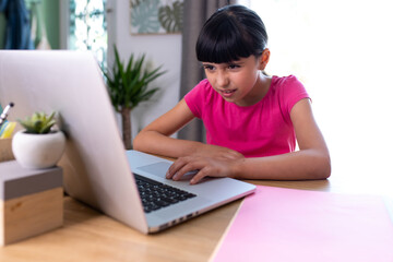 girl watching something disgusting her on a computer at home