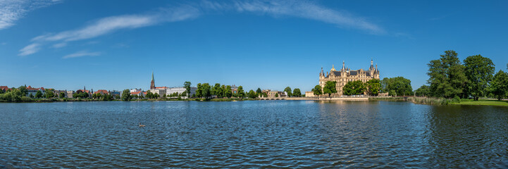 Fototapeta na wymiar Schwerin, Germany. Panoramic view of the city with the Schwerin Castle (German: Schweriner Schloß), officially founded in 1160 with multiple restorations until 1857.