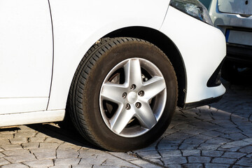 Fototapeta na wymiar A dusty and dirty car rear tire
