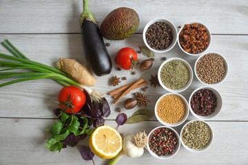 Dry seasonings, spices, herbs and vegetables on a dark background top view.