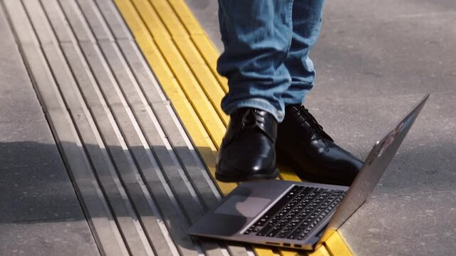 Imitation of breaking a laptop on the ground. Illustration of computer security and hacking computer systems.  Online call. Video communication over a long distance.