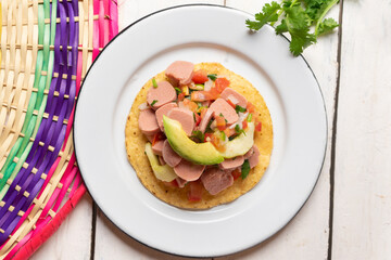 Mexican sausage ceviche with avocado on white background