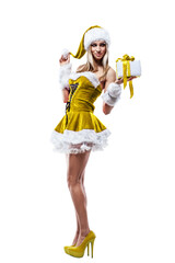 Happy young woman in santa claus costume with gift box isolated on white background. Christmas holiday. Girl in yellow holding presents
