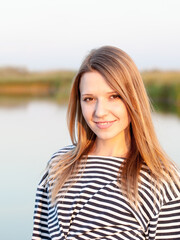 Portrait of adorable woman wearing sexy sailor T-shirt, outdoors