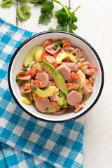 Mexican sausage ceviche with avocado on white background