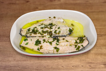 Steamed salmon trout, in the ceramic container.
