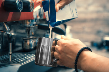 
Steamed coffee machine, barista makes coffee in a cafe