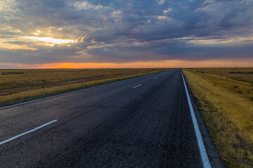 Fototapeta na wymiar Sunset view of a road in russian steppe