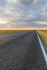 Sunset view of a road in russian steppe