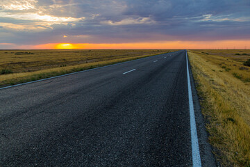 Sunset view of a road in russian steppe