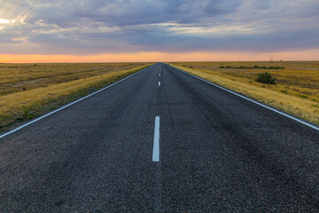 Sunset view of a road in russian steppe