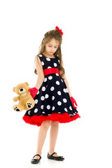 Pretty Long Haired Girl Wearing Polka Dot Dress Posing with Teddy Bear