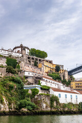 Fototapeta premium It's Beautiful houses on the coast of the River Douro in Porto, Portugal. View from the River Douro, one of the major rivers of the Iberian Peninsula (2157 m)
