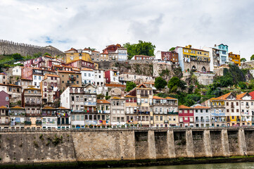 It's Beautiful houses on the coast of the River Douro in Porto, Portugal. View from the River Douro, one of the major rivers of the Iberian Peninsula (2157 m)