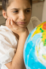 
Little beautiful girl in a white dress examines and studies the globe. Good for billboards, posters, flyers.
