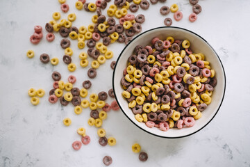Multi-colored corn rings on a white bowl for breakfast, healthy food.