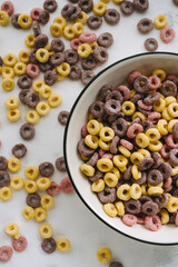 Multi-colored corn rings on a white bowl for breakfast, healthy food.